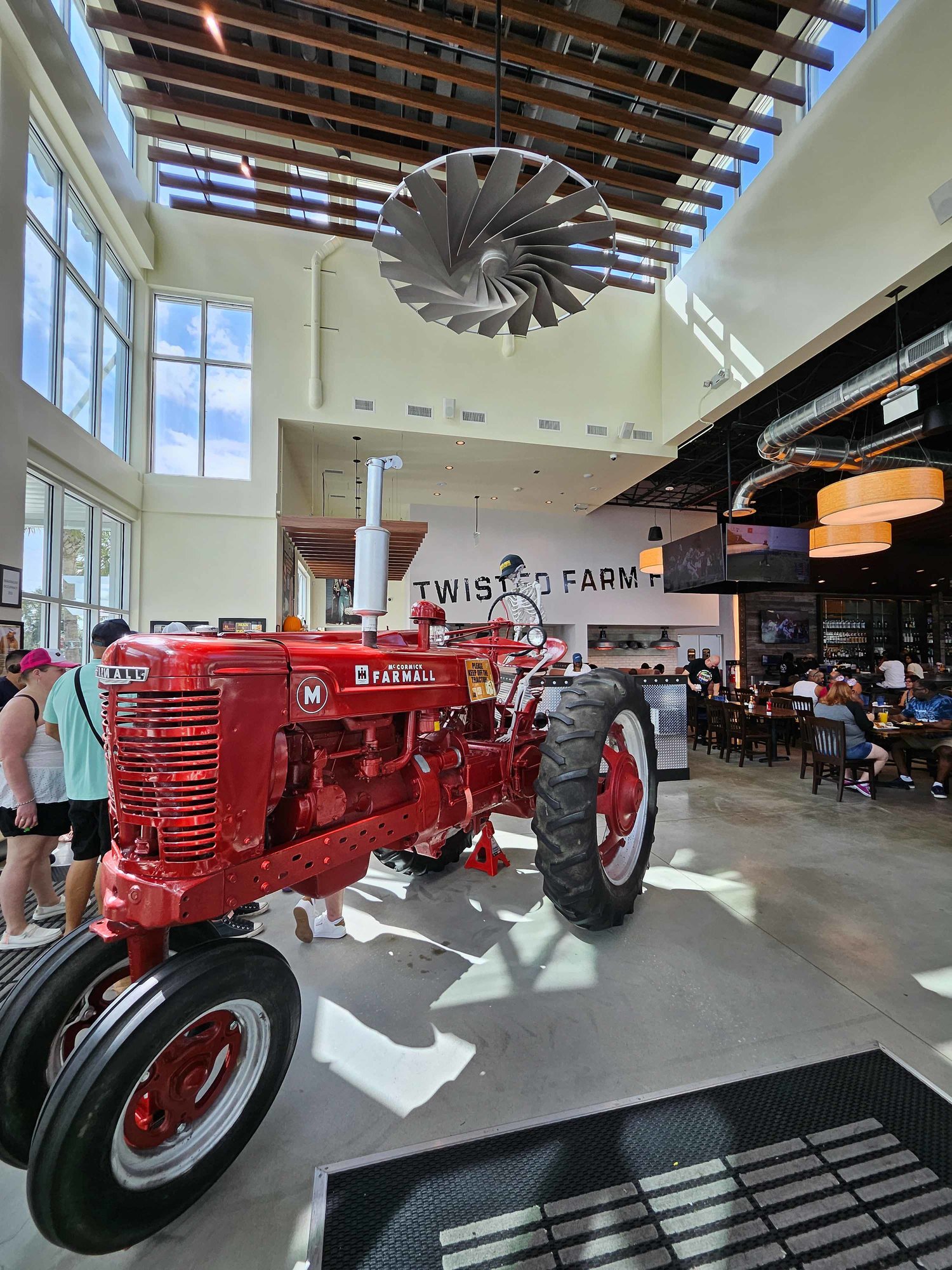 red tractor inside a restaurant waiting area with rustic decor
